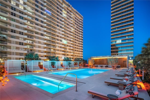 view of swimming pool with a hot tub