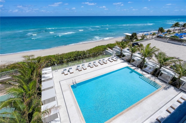 bird's eye view featuring a water view and a beach view