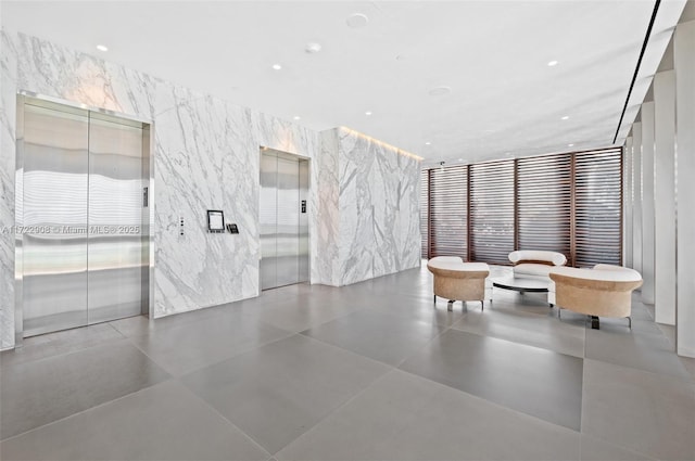 bathroom featuring a wall of windows and elevator