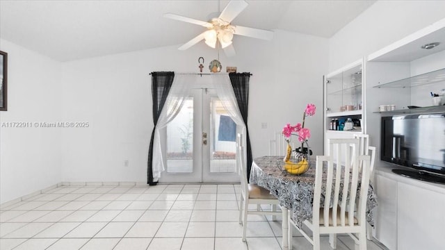 tiled dining room featuring ceiling fan, lofted ceiling, and french doors