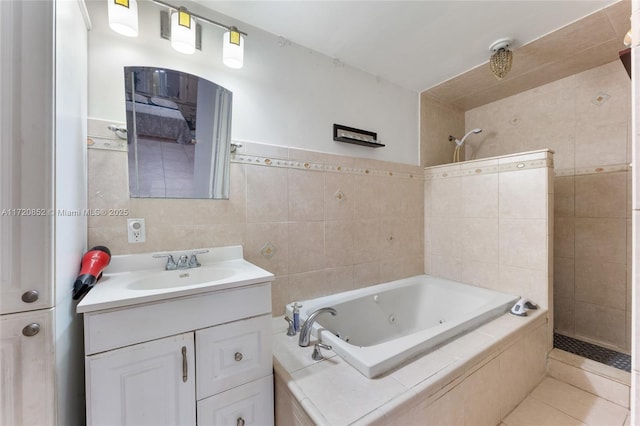 bathroom with tile patterned flooring, vanity, and tile walls