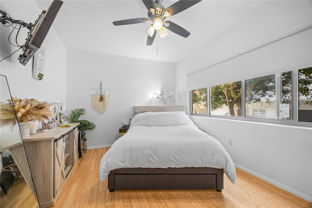 bedroom with ceiling fan and light hardwood / wood-style floors