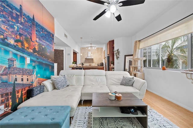 living room featuring light wood-type flooring and ceiling fan