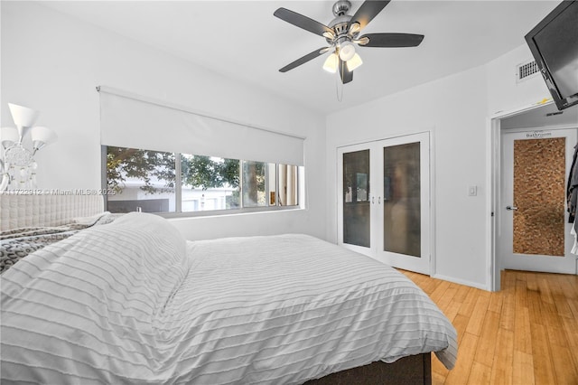 bedroom featuring ceiling fan, french doors, and light hardwood / wood-style floors