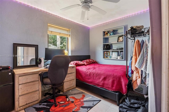 bedroom with ceiling fan and light tile patterned floors