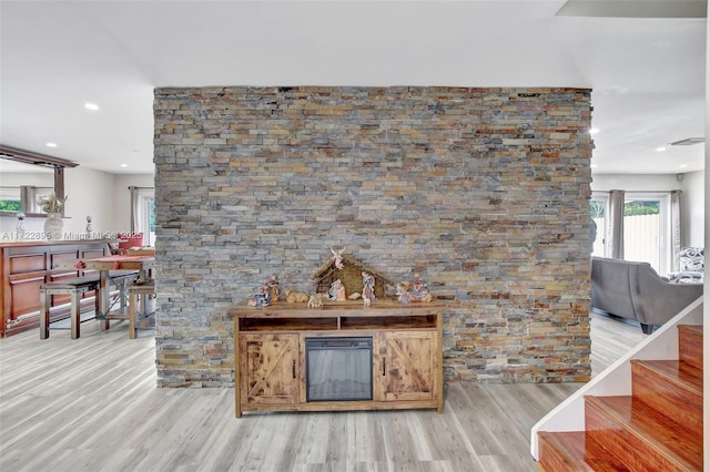 bar with light wood-type flooring