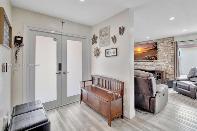 entrance foyer with light hardwood / wood-style floors and french doors