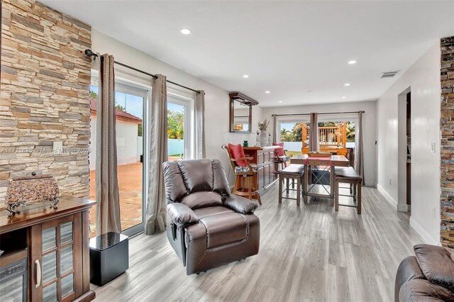 dining area featuring bar and light hardwood / wood-style flooring