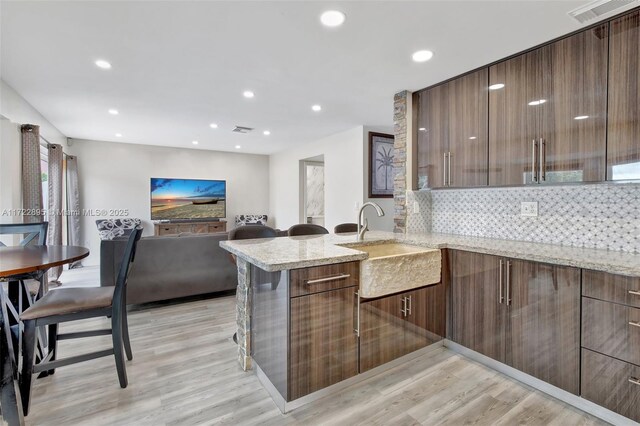 dining space featuring plenty of natural light and light hardwood / wood-style floors