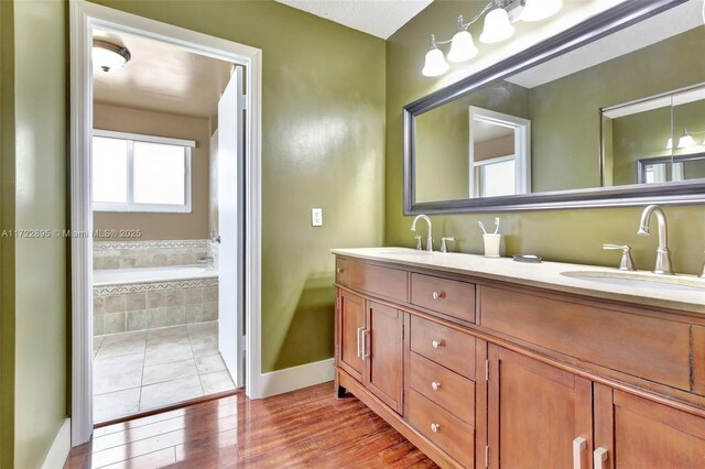 bathroom with tile patterned floors, toilet, a bidet, and tiled tub