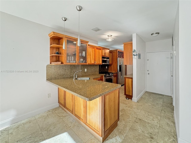 kitchen with kitchen peninsula, appliances with stainless steel finishes, backsplash, and sink