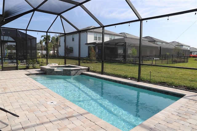 view of pool with a lawn, a patio area, a lanai, and an in ground hot tub