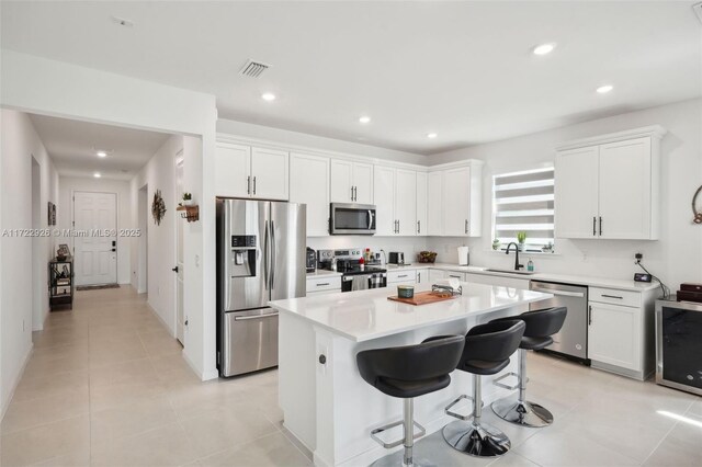 dining space with a raised ceiling, ceiling fan, and light tile patterned flooring