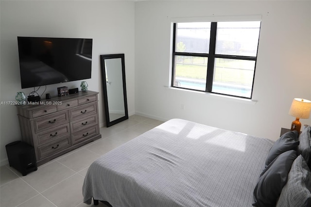 tiled bedroom featuring multiple windows