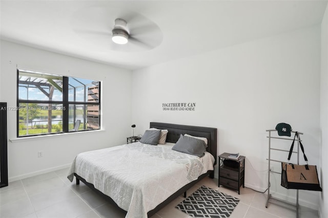 bedroom featuring tile patterned flooring, baseboards, and ceiling fan