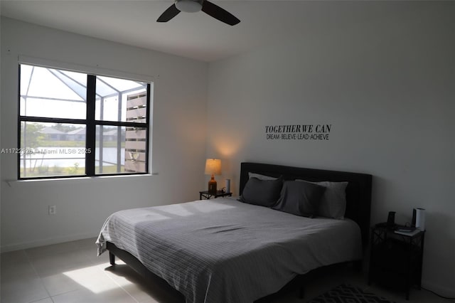 tiled bedroom featuring ceiling fan