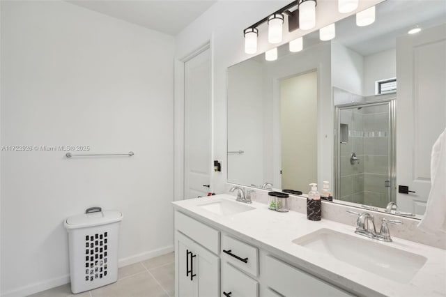 bathroom with baseboards, a sink, tile patterned flooring, and a shower stall