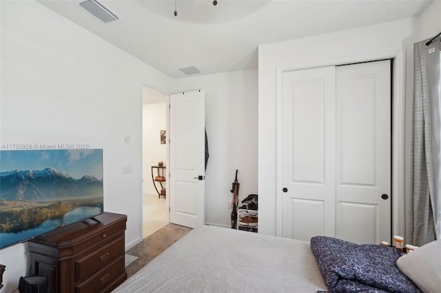bedroom with a closet and visible vents