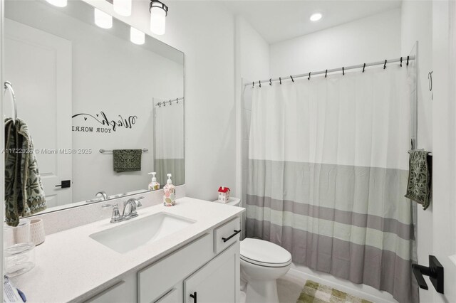 full bathroom featuring toilet, vanity, and a shower with shower curtain