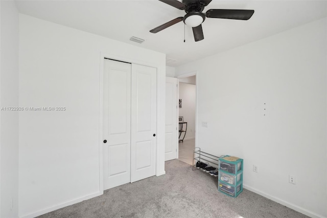 unfurnished bedroom featuring baseboards, visible vents, a closet, and carpet