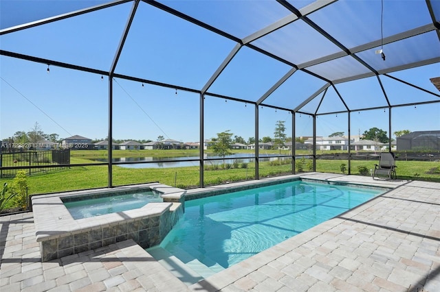 view of swimming pool with glass enclosure, a pool with connected hot tub, a yard, and a patio area
