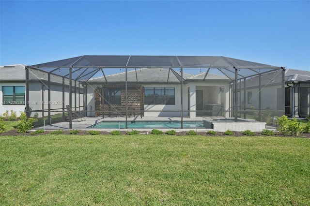rear view of property with an outdoor pool, a patio, and a yard
