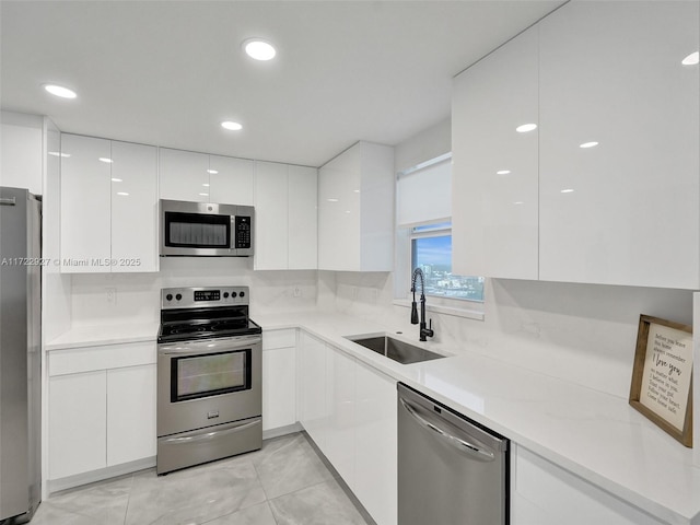 kitchen with white cabinets, sink, and stainless steel appliances