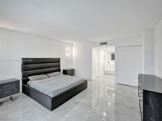 bedroom featuring ensuite bath and a closet