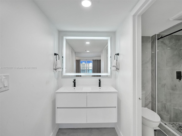 bathroom with vanity, an enclosed shower, and toilet