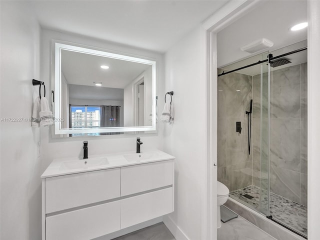 bathroom featuring vanity, toilet, and an enclosed shower