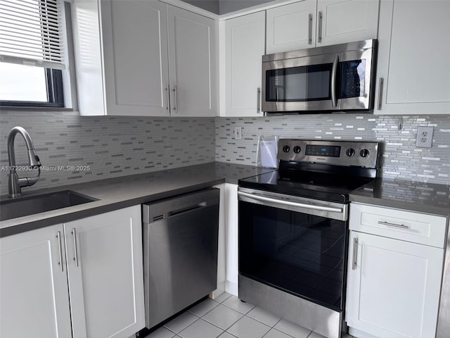 3300 NE 192nd St Unit 918, Aventura, FL 33180 - kitchen with light tile patterned floors, stainless steel appliances, white cabinets, and a sink