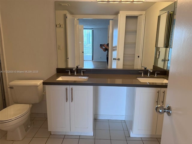 bathroom with vanity, tile patterned floors, and toilet