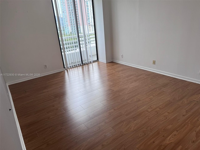 3300 NE 192nd St Unit 918, Aventura, FL 33180 - empty room featuring dark wood-style flooring and baseboards