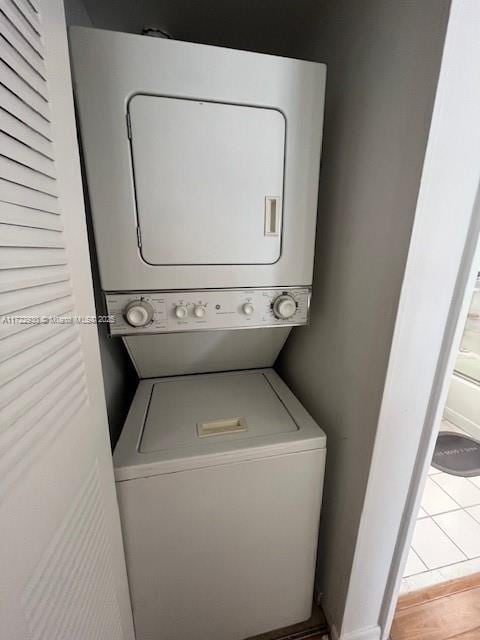 3300 NE 192nd St Unit 918, Aventura, FL 33180 - washroom with stacked washer and dryer, laundry area, and baseboards