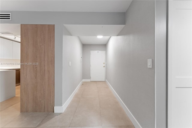 hall featuring light tile patterned flooring