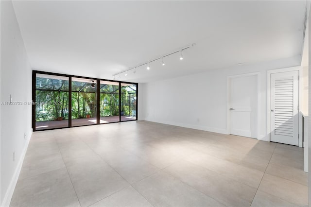 unfurnished room with floor to ceiling windows