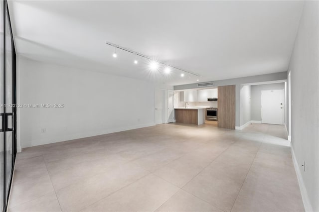 unfurnished living room featuring sink