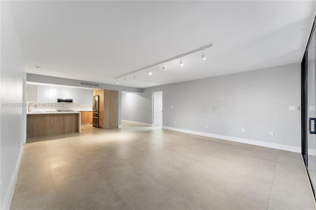 unfurnished living room with sink