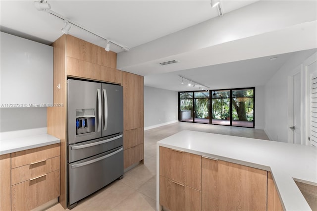 kitchen featuring stainless steel fridge with ice dispenser, rail lighting, and light tile patterned floors