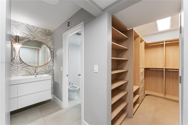 spacious closet featuring light tile patterned floors