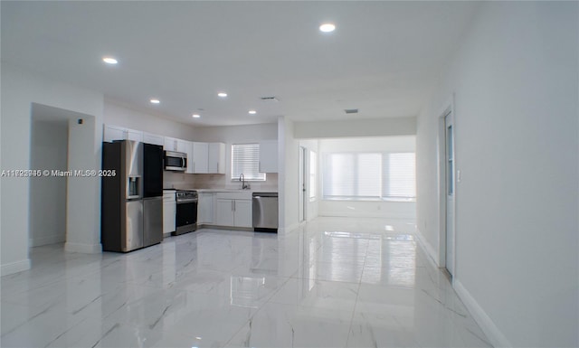 kitchen with white cabinets, appliances with stainless steel finishes, and sink