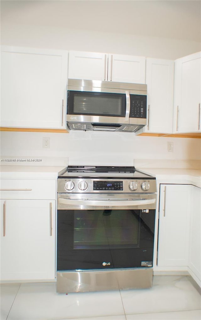 kitchen with appliances with stainless steel finishes and white cabinetry