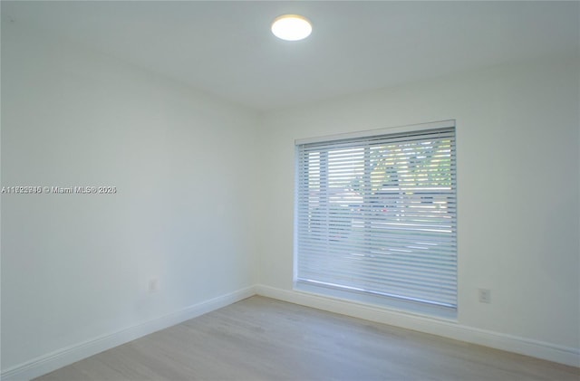 unfurnished room with light wood-type flooring