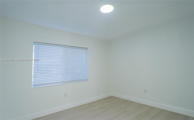 spare room with light hardwood / wood-style floors