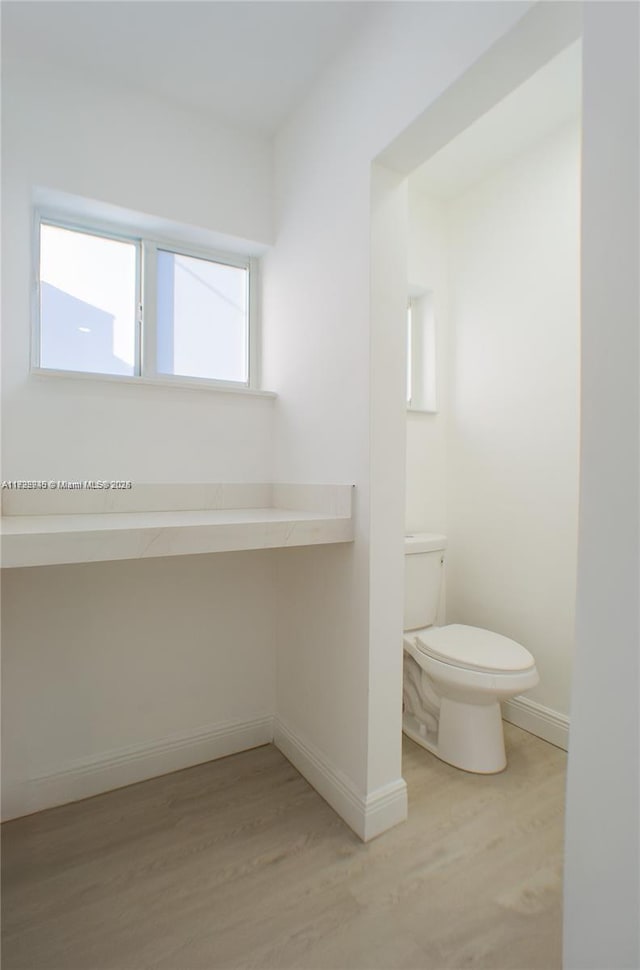 bathroom featuring toilet and hardwood / wood-style flooring