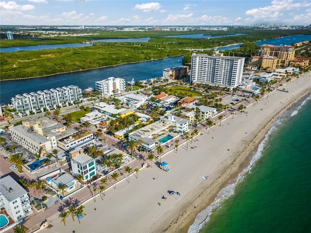 bird's eye view featuring a water view and a beach view