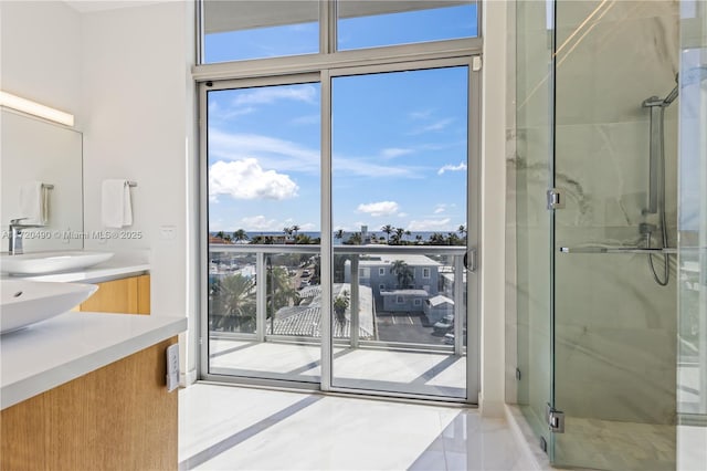 bathroom with vanity and a shower with shower door