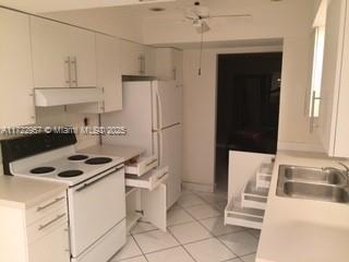 kitchen with ceiling fan, white cabinetry, sink, white electric range, and light tile patterned floors