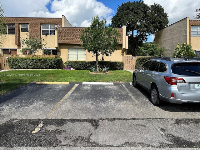 view of parking featuring a lawn