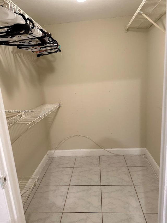 spacious closet with tile patterned floors